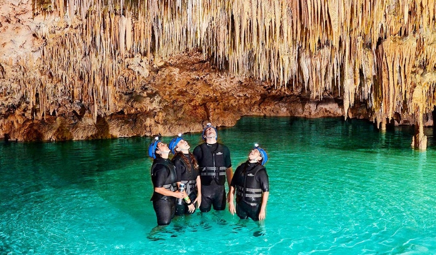 people diving in a cenote in mexico 