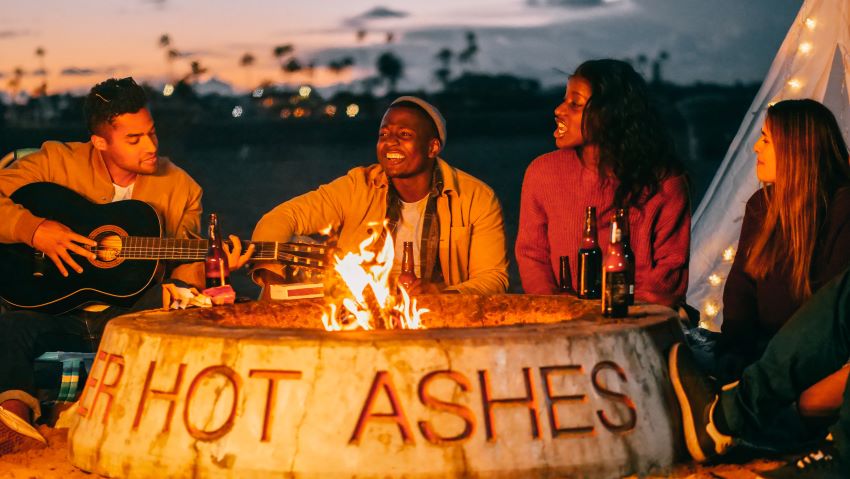 people singing by a campfire