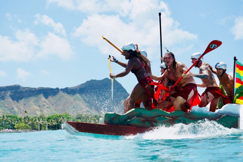 team kayaking in the ocean