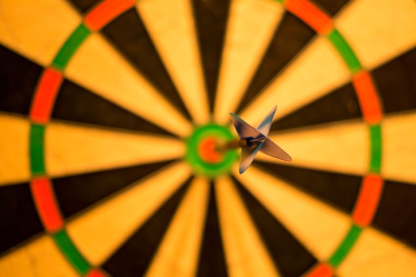 dart board with a dart in it for goal and objective of corporate retreat