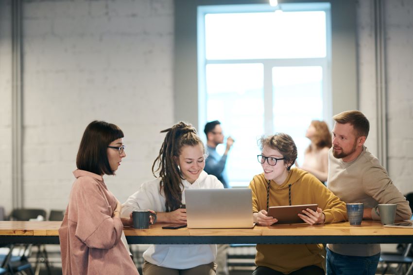 four colleagues talking to each other