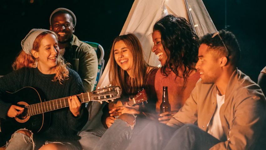 people singing around a campfire