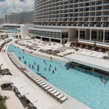 aerial view of people in the pool and resort buildings at ava resort cancun