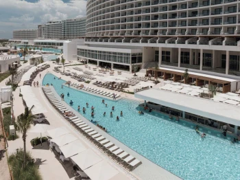 aerial view of people in the pool and resort buildings at ava resort cancun