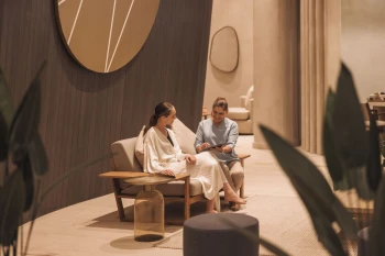 Lady talking to a massage therapist at AVA Resort Cancun