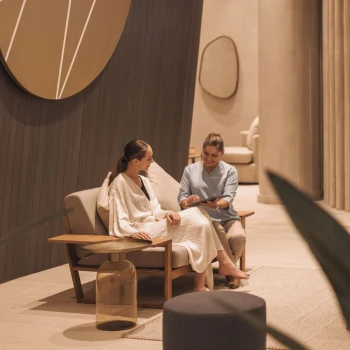 Lady talking to a massage therapist at AVA Resort Cancun