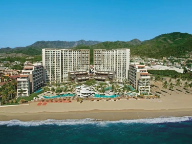 aerial view of the buildings and pools and beach of dreams and secrets vallarta bay in Mexico