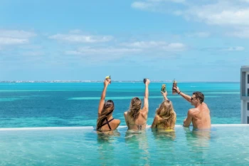 people in the rooftop pool at Garza Blanca Cancun