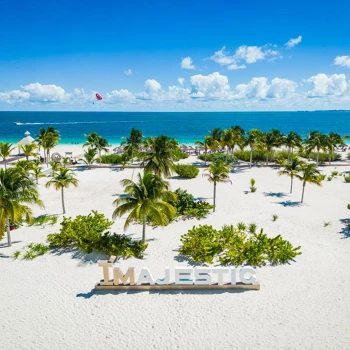 beach at Majestic Elegance Costa Mujeres with the resort branding