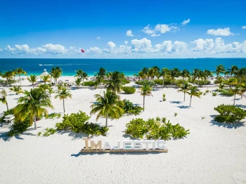 beach at Majestic Elegance Costa Mujeres with the resort branding