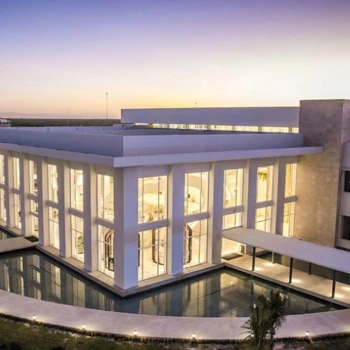 Majestic Elegance Costa Mujeres buildings lit up in the evening