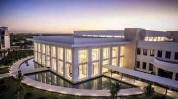 Majestic Elegance Costa Mujeres buildings lit up in the evening