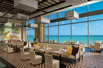 Market Cafe restaurant with chic seating and stunning floor-to-ceiling windows overlooking the ocean.