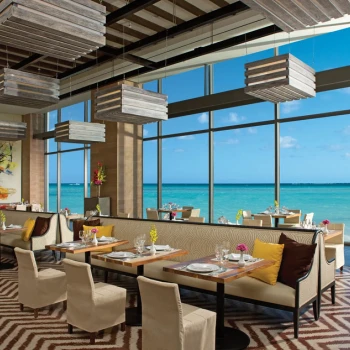 Market Cafe restaurant with chic seating and stunning floor-to-ceiling windows overlooking the ocean.