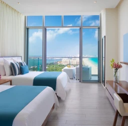 Preferred Club double room with bright floor-to-ceiling windows and a breathtaking ocean view balcony.