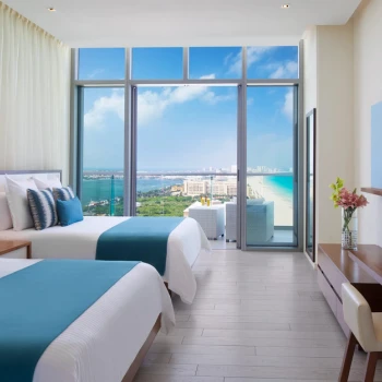 Preferred Club double room with bright floor-to-ceiling windows and a breathtaking ocean view balcony.