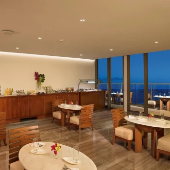 Preferred Club Lounge at sunset with floor-to-ceiling windows and a buffet display area.