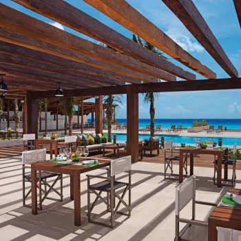 Sea Salt Grill, an open-air restaurant with wooden beams, overlooking the pool and Caribbean Sea.
