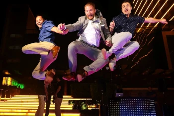 A successful corporate event! Attendees celebrate at night during a fun team retreat party at Secrets The Vine Cancun.