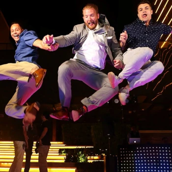 A successful corporate event! Attendees celebrate at night during a fun team retreat party at Secrets The Vine Cancun.