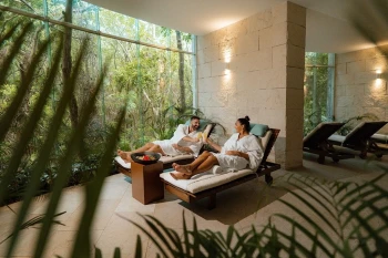 man and woman at the spa at the beachfront by fives resort