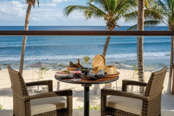 delicious room service breakfast kept on oceanfront balcony table at The Beachfront by The Fives