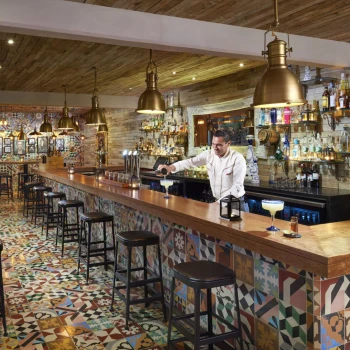 bartender at the bar at The Fives Beach Hotel and Residences