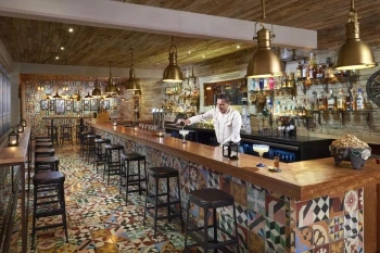 bartender at the bar at The Fives Beach Hotel and Residences