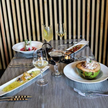 table spread with delicious food and drinks at The Fives Beach Hotel and Residences