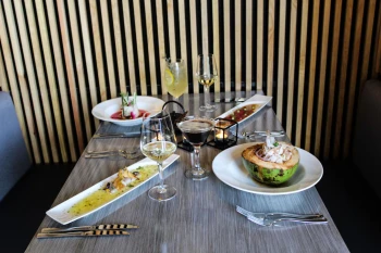 table spread with delicious food and drinks at The Fives Beach Hotel and Residences